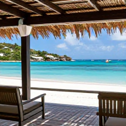 Caribbean Holidays, July Nature Holidays, Traveller enjoying a shaded tropical terrace overlooking a turquoise bay on Saint Barth&eacute;lemy in July