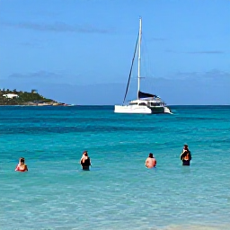 Caribbean Holidays, July Tours, Catamaran sailing near Saint Martin in July, snorkellers in clear turquoise water, sunny sky and unspoilt coastline