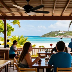 Caribbean Holidays, July Walking Holidays, Happy holidaymakers relaxing at a Caribbean cafe after a July walk on Saint Martin, with tropical scenery and sea views
