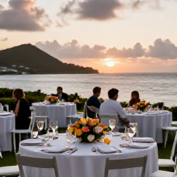 Caribbean Holidays, July Weddings, Elegant outdoor wedding reception in the United States Virgin Islands, with tropical flowers, simple table settings and guests dining near the sea at sunset