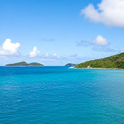 Caribbean Holidays, June Adventures, A bright June morning overlooking turquoise water, green islands and a sailing boat in the British Virgin Islands
