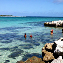 Caribbean Holidays, June Beach Holidays, Visitors snorkelling in clear shallow water near a Saint Barth&eacute;lemy beach, colourful fish, rocky reef and a sunny Caribbean coastline