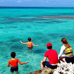 Caribbean Holidays, June Family Holidays, Family snorkelling in clear turquoise water near a colourful coral reef in the Turks and Caicos Islands