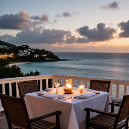 Caribbean Holidays, June Luxury Holidays, Romantic fine dining table on a Caribbean terrace in Saint Kitts at dusk, with candles, fresh seafood and ocean views