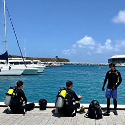 Caribbean Holidays, June Scuba Diving, Friendly scuba diving group preparing equipment beside a tropical marina in Sint Maarten