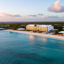Caribbean Holidays, Luxury Caribbean Holidays, Aerial view of Bonaire&rsquo;s turquoise Caribbean sea, calm coastline and elegant beachfront resort at golden hour