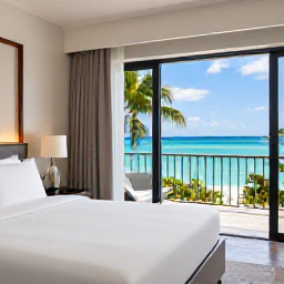 Caribbean Holidays, Luxury Caribbean Holidays, Stylish Caribbean hotel room with balcony overlooking a bright blue sea, fresh white bedding and tropical greenery