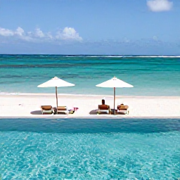 Caribbean Holidays, Luxury February, Luxury infinity pool beside a sandy beach in Nevis, with a couple relaxing under parasols and turquoise water beyond