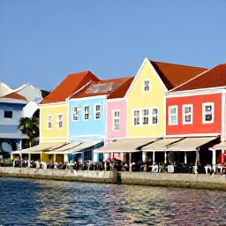 Caribbean Holidays, Luxury Holidays Cura&ccedil;ao, Colourful historic Willemstad street beside a waterfront, with pastel buildings, caf&eacute;s and relaxed visitors in Cura&ccedil;ao