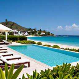 Caribbean Holidays, Luxury Holidays, Private infinity pool overlooking a Caribbean beach in Saint Martin, luxury sun loungers, tropical gardens and clear blue water