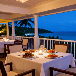 Caribbean Holidays, Luxury March, Outdoor table at a refined Grand Case restaurant with Caribbean seafood, candles and a relaxed evening atmosphere