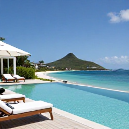 Caribbean Holidays, Luxury Saint Barth&eacute;lemy, A luxury beachfront villa on Saint Barth&eacute;lemy with an infinity pool, sun loungers and a view over a calm turquoise bay