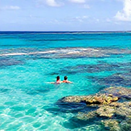 Caribbean Holidays, March Honeymoons, Newlywed couple swimming in clear turquoise water and snorkelling above colourful Caribbean reef near Saint Kitts and Nevis