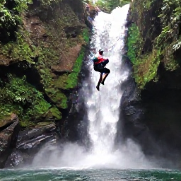Caribbean Holidays, Martinique Adventure Holidays, Visitors canyoning through a green river gorge and waterfall in northern Martinique