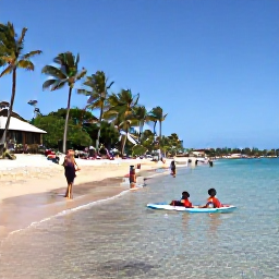 Caribbean Holidays, Martinique Family Holidays, Children paddling in shallow clear water on a sandy Martinique beach while parents relax under palm trees