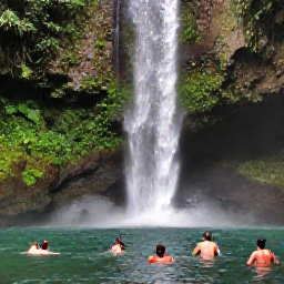 Caribbean Holidays, Martinique Nature Holidays, Tropical waterfall surrounded by green forest in northern Martinique, with visitors swimming in a natural pool