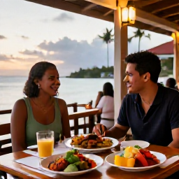 Caribbean Holidays, Martinique Tours, A couple dining at an outdoor Creole restaurant in Martinique at sunset, with colourful dishes and a relaxed island atmosphere