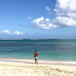 Caribbean Holidays, Martinique Wellness, A tranquil Martinique beach in June with soft golden sand, calm turquoise water and a person walking beside the sea