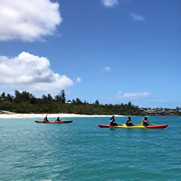 Caribbean Holidays, May Adventures, Visitors kayaking through calm turquoise water beside a green Caribbean coastline in Saint Martin