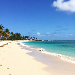 Caribbean Holidays, May Beach Holidays, Wide golden beach on Saint Kitts with calm turquoise Caribbean water, palm trees and a sunny May sky