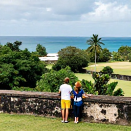 Caribbean Holidays, May Honeymoons, Couple exploring the historic Brimstone Hill Fortress on Saint Kitts, stone walls, tropical greenery and ocean views