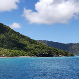 Caribbean Holidays, May Nature Holidays, Lush tropical coastline and forested hills on Saint Vincent and the Grenadines in May, with calm blue sea and scattered clouds