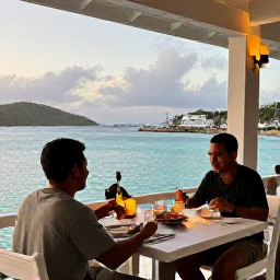 Caribbean Holidays, May Solo Holidays, A solo traveller enjoying a relaxed evening meal at a waterfront restaurant in the British Virgin Islands