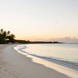 Caribbean Holidays, May Wellness Escape, Quiet white-sand beach in Turks and Caicos at sunrise, calm turquoise water and a relaxed wellness holiday atmosphere