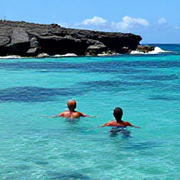 Caribbean Holidays, Montserrat Beach Holidays, A couple swimming and snorkelling in clear Caribbean water near Montserrat, with colourful fish and a rugged volcanic coastline