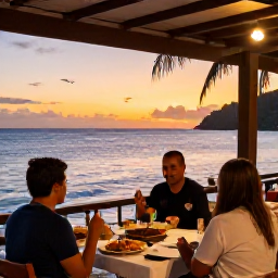 Caribbean Holidays, Montserrat Beach Holidays, A relaxed outdoor dinner at a small Montserrat restaurant overlooking the sea at sunset, local Caribbean food and a friendly island atmosphere
