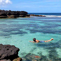 Caribbean Holidays, Montserrat Beach Holidays, A snorkeller exploring clear Caribbean water near Montserrat, with colourful fish, rocky reef and a volcanic coastline beyond