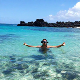 Caribbean Holidays, Montserrat Beach Holidays, A traveller snorkelling in clear Caribbean water near Montserrat, with colourful fish, volcanic rocks and a bright March sky