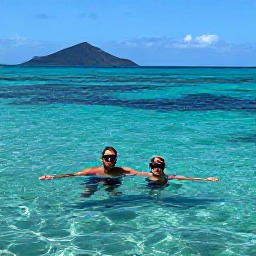 Caribbean Holidays, Montserrat Couples Holidays, Couple snorkelling in clear turquoise water near Montserrat, with colourful fish and a volcanic coastline in the background
