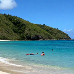 Caribbean Holidays, Montserrat Family Holidays, A family swimming and paddling in calm clear Caribbean water beside a quiet Montserrat beach, with green hills behind