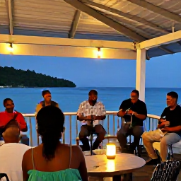 Caribbean Holidays, Montserrat Holidays, Friendly evening scene in Montserrat with local musicians performing Caribbean music near a waterfront restaurant