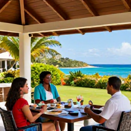 Caribbean Holidays, Montserrat Holidays, Guests enjoying a welcoming all-inclusive resort in Montserrat, with an outdoor dining area, tropical gardens and views towards the Caribbean Sea