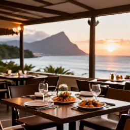 Caribbean Holidays, Montserrat Luxury Holidays, Elegant open-air restaurant in Montserrat serving fresh Caribbean seafood at sunset with the sea in the background
