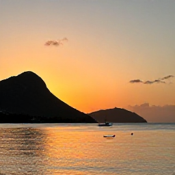Caribbean Holidays, Montserrat Tours July, A peaceful sunset over Montserrat&rsquo;s Caribbean coastline, with silhouetted hills and a small boat on calm water