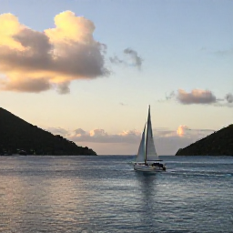 Caribbean Holidays, November Adventures, Small sailing boat passing between tropical islands at golden hour in the United States Virgin Islands