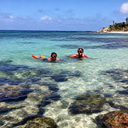 Caribbean Holidays, November Beaches, A couple snorkelling in clear shallow water near a Caribbean beach in Saint Martin, with colourful fish and rocky reefs visible below