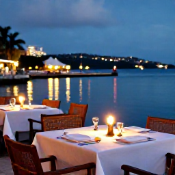 Caribbean Holidays, November Honeymoons, Romantic evening dinner at a waterfront restaurant in Saint Kitts, candles, local food and softly lit harbour