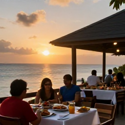 Caribbean Holidays, October Adventures, A small open-air Caribbean restaurant overlooking the sea at sunset, with local food and travellers relaxing after an active day