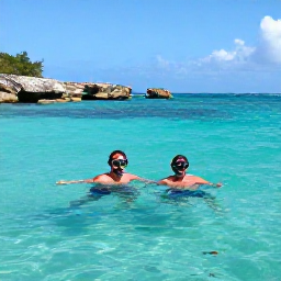 Caribbean Holidays, October Beach Holidays, Couple snorkelling in clear Caribbean water near Saint Martin, colourful fish, rocky coves and sunny October conditions