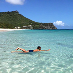 Caribbean Holidays, October Beach Holidays, Traveller swimming in clear shallow water at Anse des Salines, Saint Barth&eacute;lemy, with a sandy beach and green hills