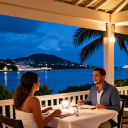 Caribbean Holidays, October Couples Holidays, Couple dining at an elegant open-air restaurant in Gustavia, Saint Barth&eacute;lemy, with harbour lights and tropical evening scenery