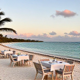 Caribbean Holidays, October Cruises, Outdoor dining beside a turquoise Caribbean beach at sunset on Grand Turk, with relaxed holiday atmosphere and soft evening light