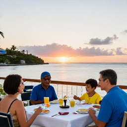 Caribbean Holidays, October Family Holidays, Family enjoying an outdoor Caribbean restaurant meal at sunset in St Thomas, United States Virgin Islands