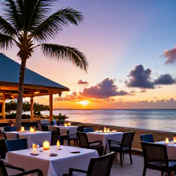 Caribbean Holidays, October Holidays, A colourful Caribbean sunset over the sea viewed from a Saint Martin beachfront restaurant, with tables and gentle evening light