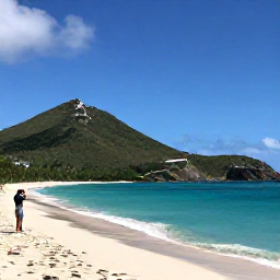 Caribbean Holidays, October Instagram Spots, White-sand beach at Colombier in Saint Barth&eacute;lemy, turquoise sea, green hills and a person taking a scenic photograph