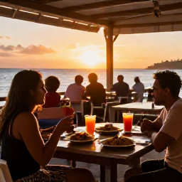Caribbean Holidays, October Island Hopping, An informal Caribbean seaside restaurant at sunset, with local dishes, colourful drinks and diners enjoying a relaxed October evening